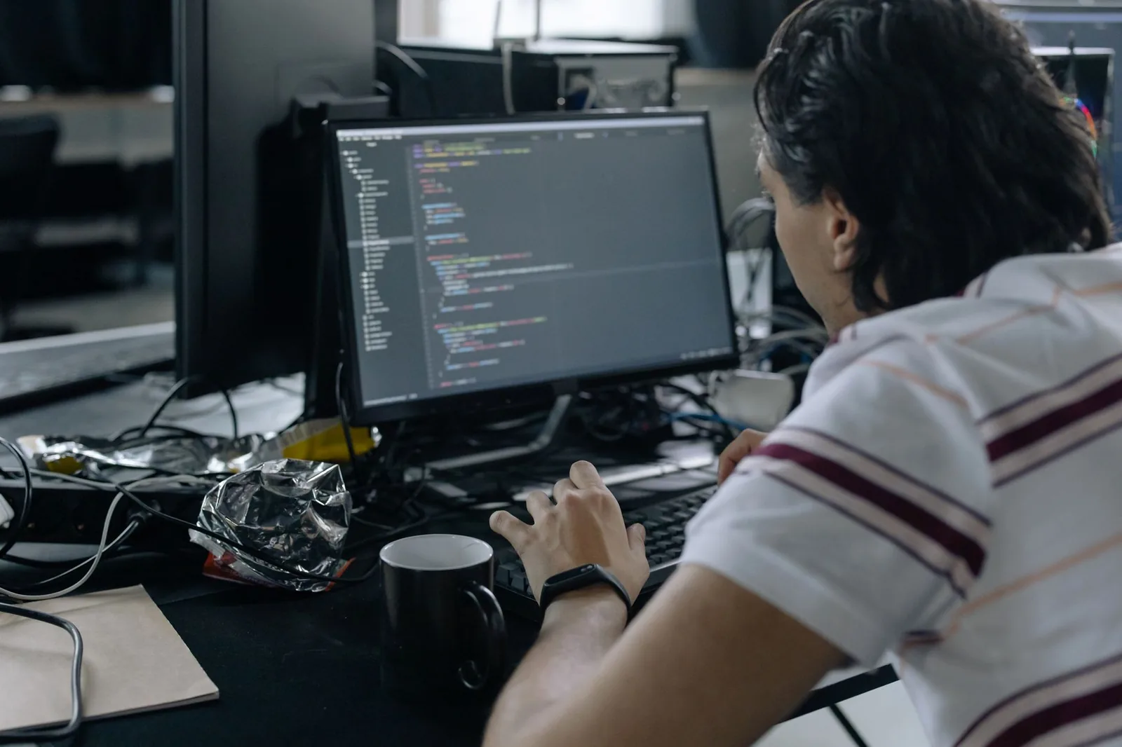 Developer workstation with AI agent tools on screen, representing how non-coders can build AI agents