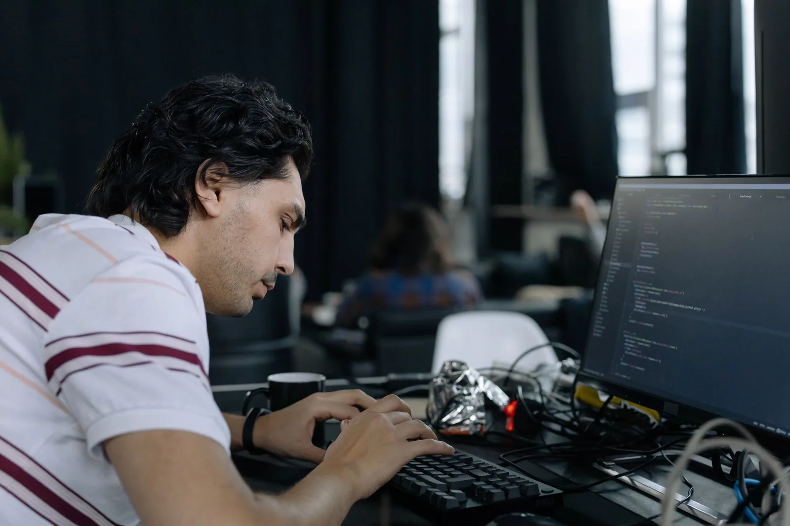 Developer workstation showing AI agent code and prompt engineering on screen for generative AI production