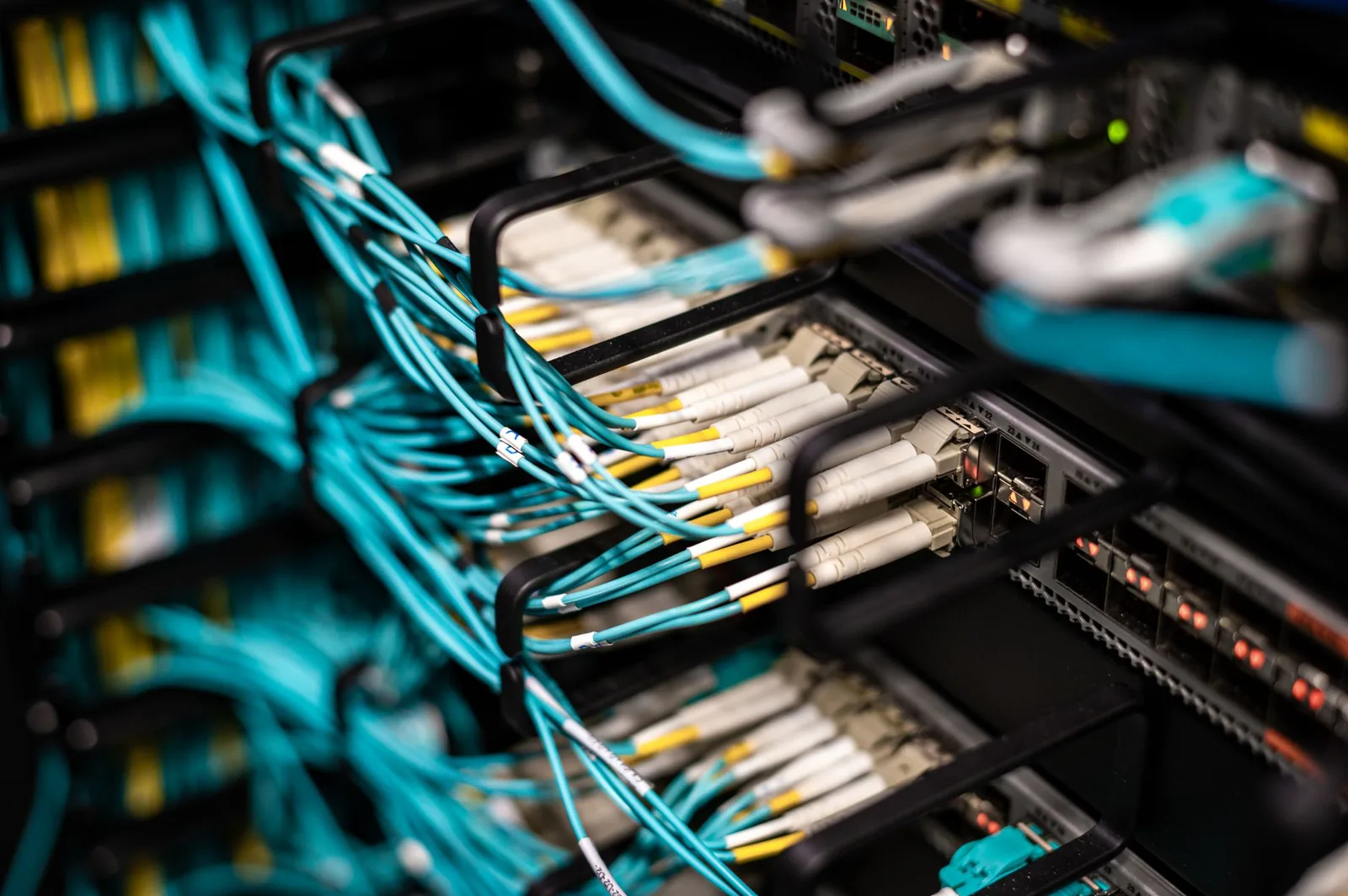 Rows of networked servers with glowing cables, representing how agents communicate in production systems