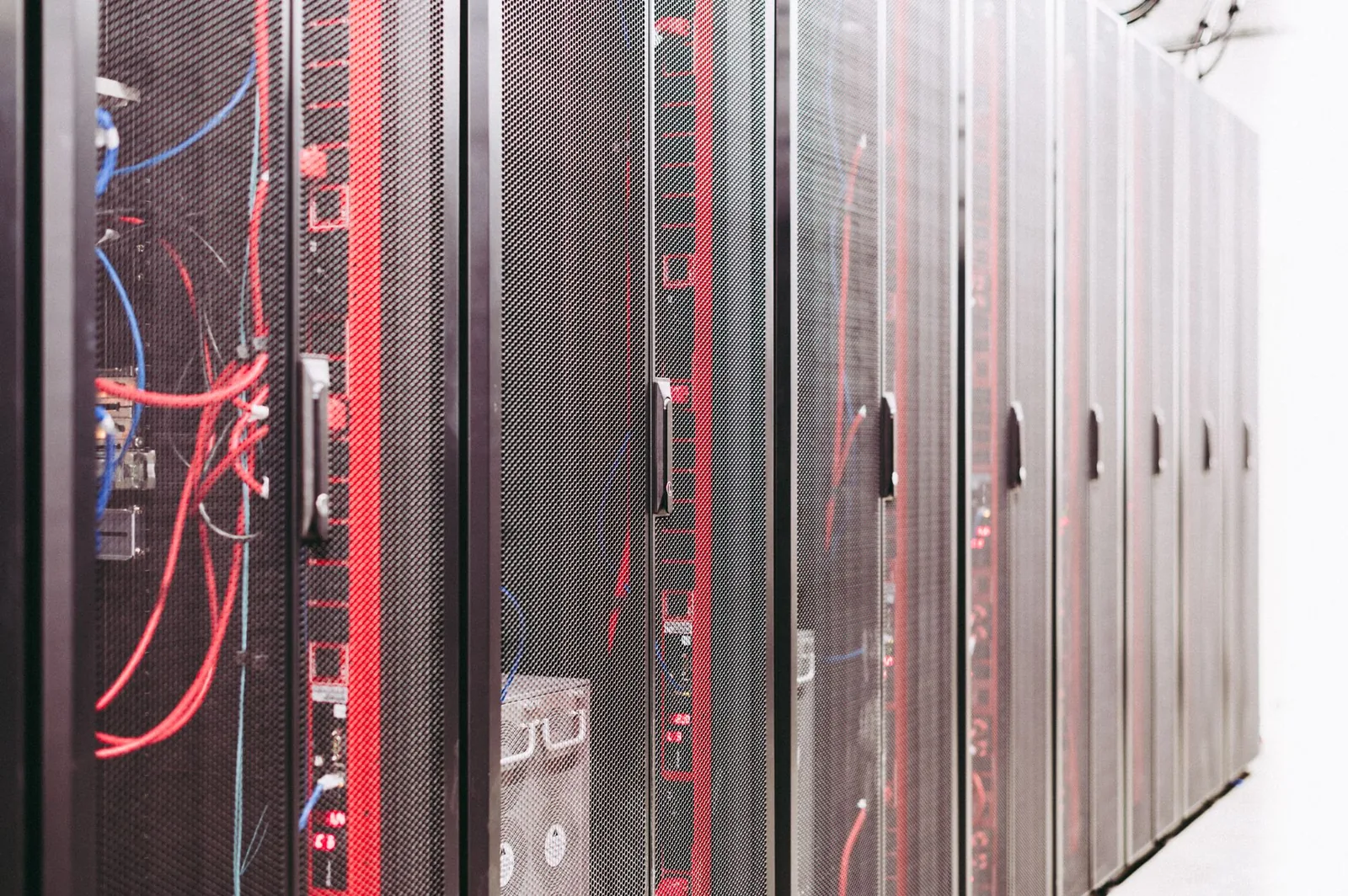 Server racks with glowing blue lights representing automated n8n production workflows running autonomously