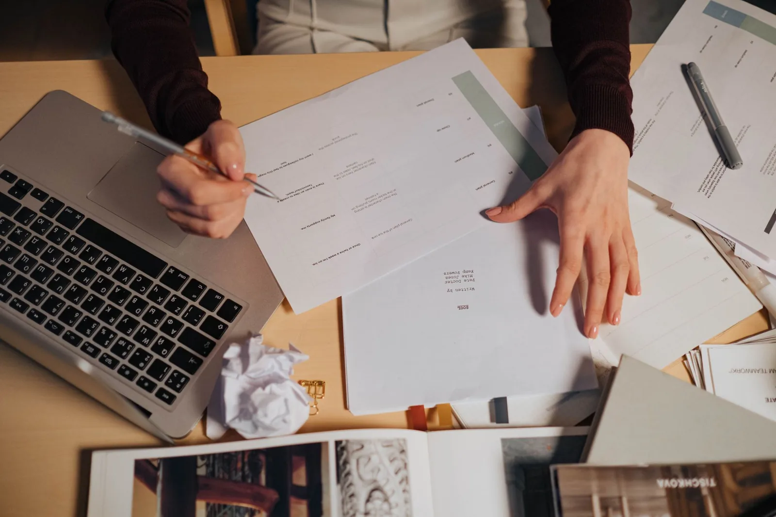 Laptop and paper invoices on a desk, illustrating automated invoice processing with an AI agent
